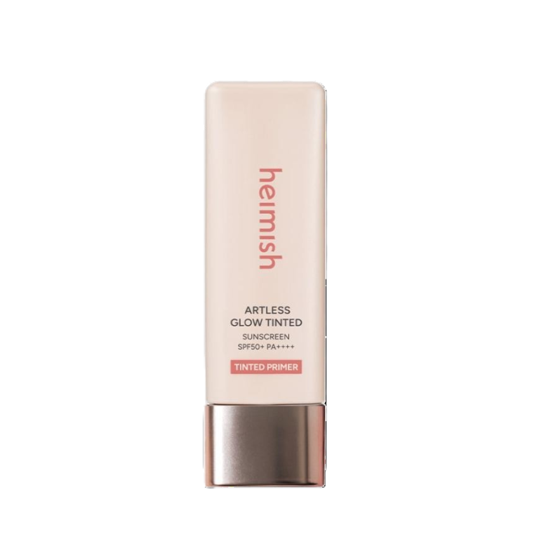 En rektangulær, lys beige tube med Heimish - Artless Glow Tinted Sunscreen Shine Beige SPF50+ PA+++ med en pink hætte. Produktnavn og mærke er trykt i pink og gråt på forsiden.