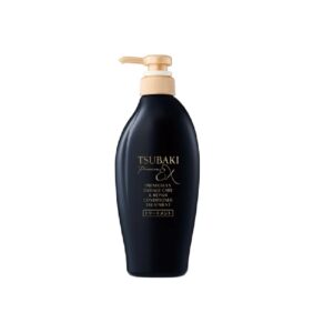 En sort pumpeflaske med Tsubaki Premium EX Damage Care Conditioner Treatment med guld og hvid tekst på forsiden mod en almindelig hvid baggrund.