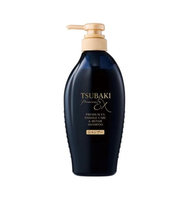 En flaske Shiseido - Tsubaki Premium EX Damage Care & Repair Shampoo med guldpumpe og mørkeblå krop, med guld og hvid tekst på frontetiketten, vises mod en almindelig hvid baggrund.